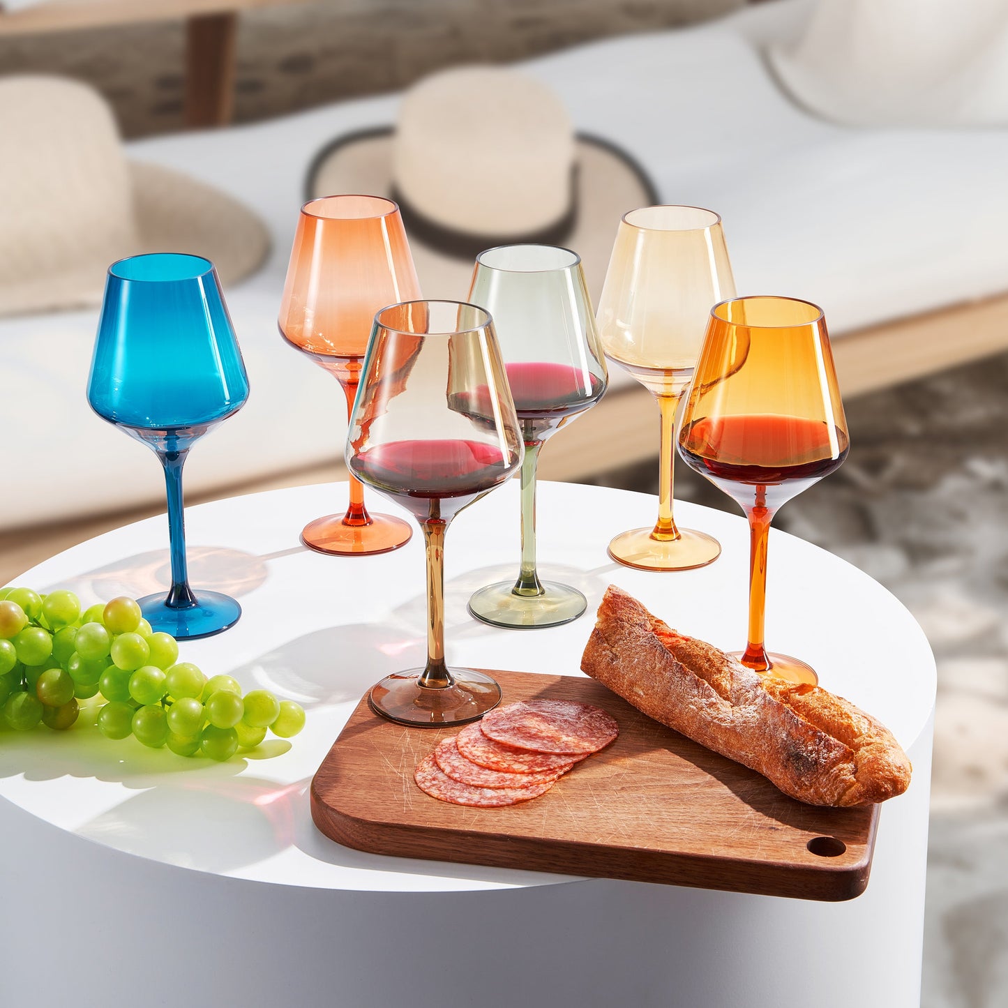 Assorted acrylic stemmed wine glasses in blue, orange, gold, and clear