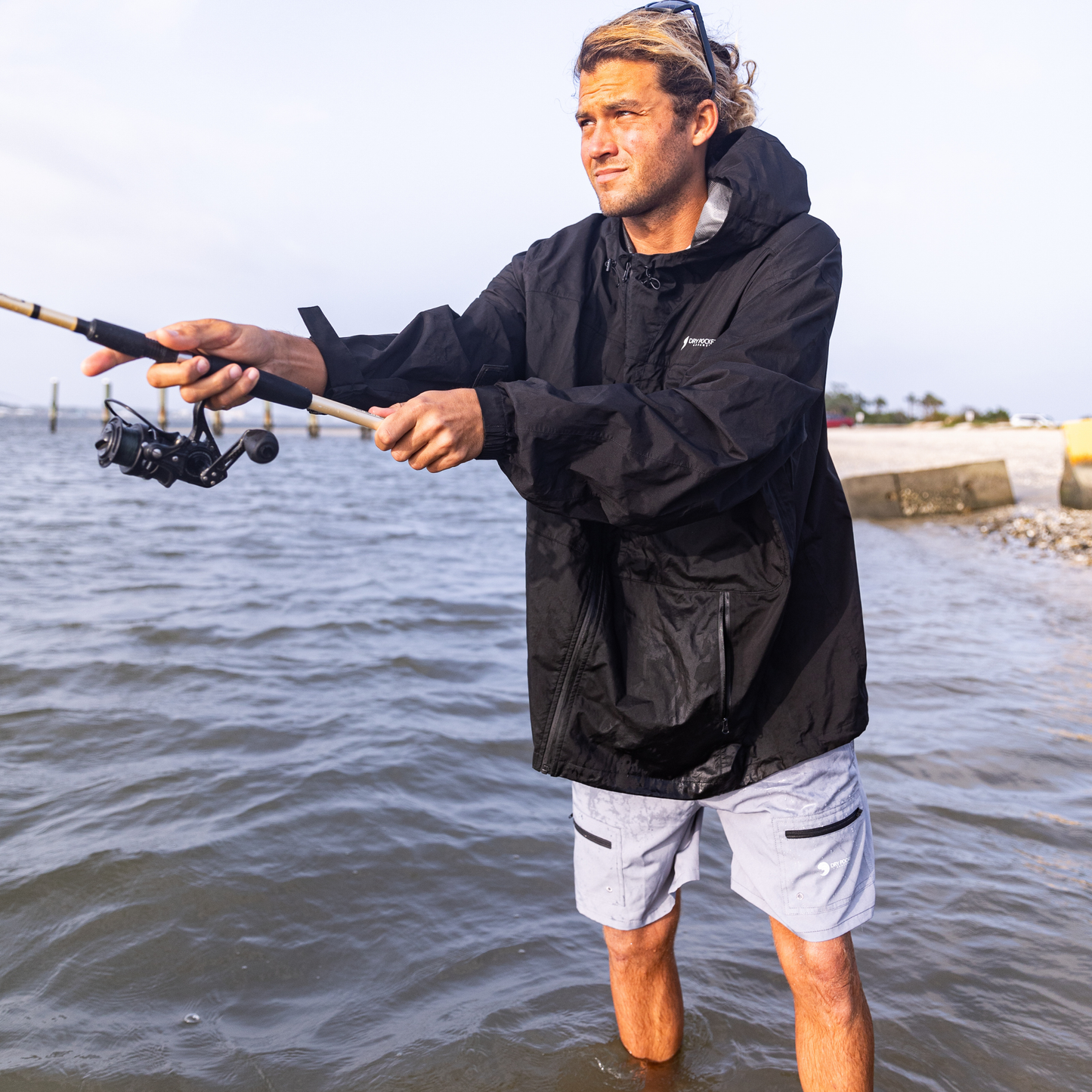 Light gray waterproof shorts on wearer, elastic waistband and zip side pockets