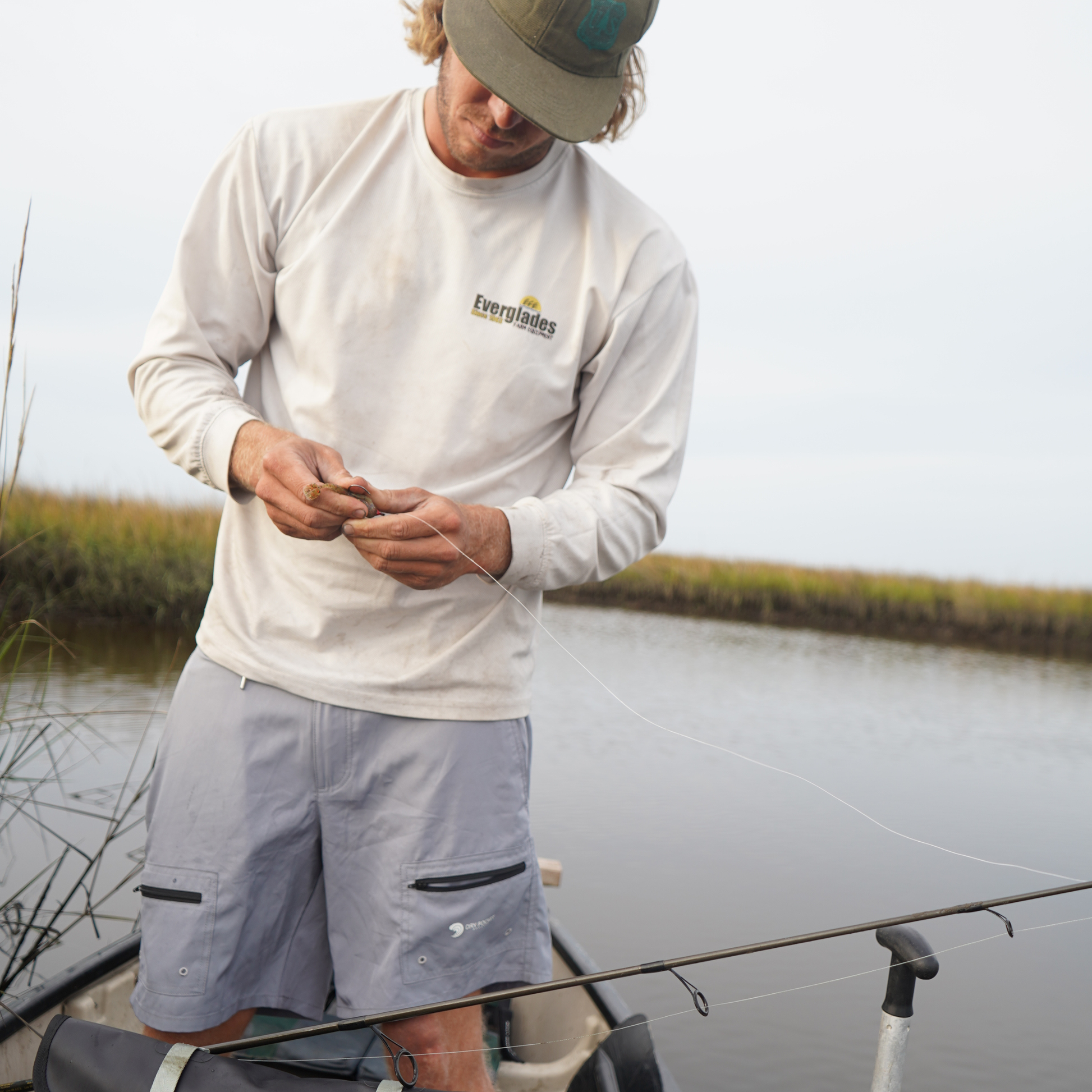 Light gray waterproof shorts with two flap side pockets and elastic waistband