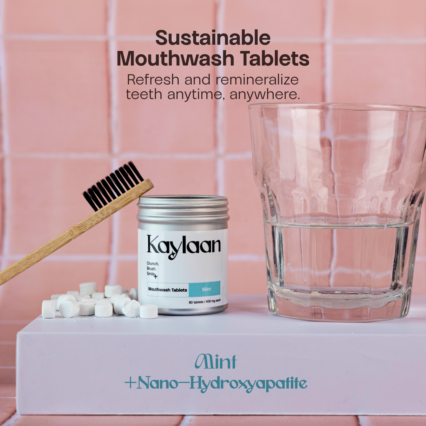 Mouthwash tablets jar with mint label, tablets on tray, and a glass