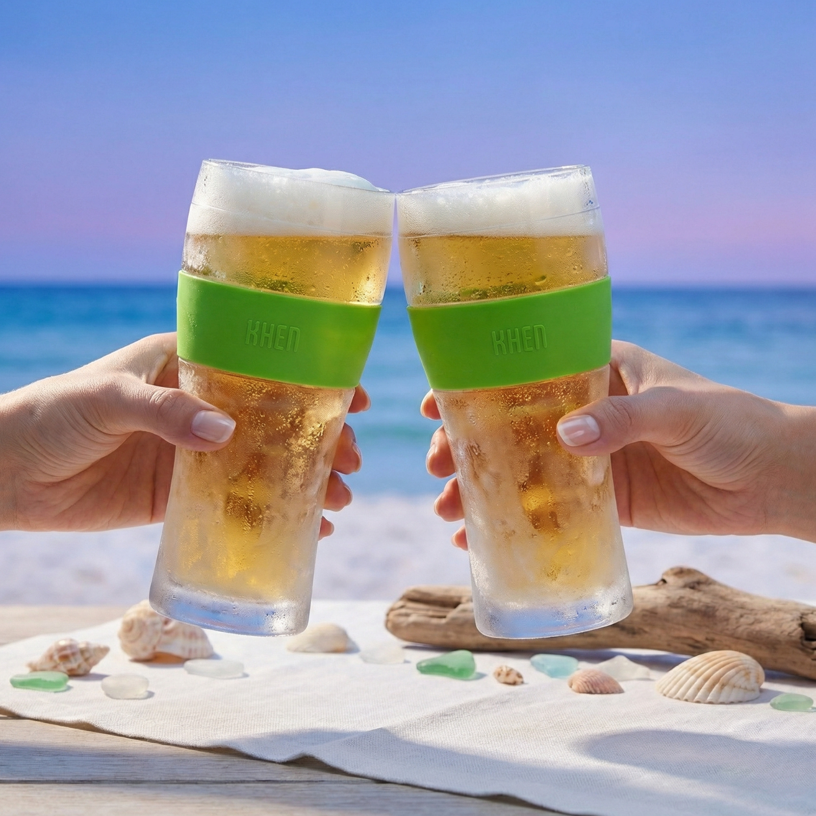 Two tall acrylic cooling beer glasses with frosted tops and green band (KHEN), held up
