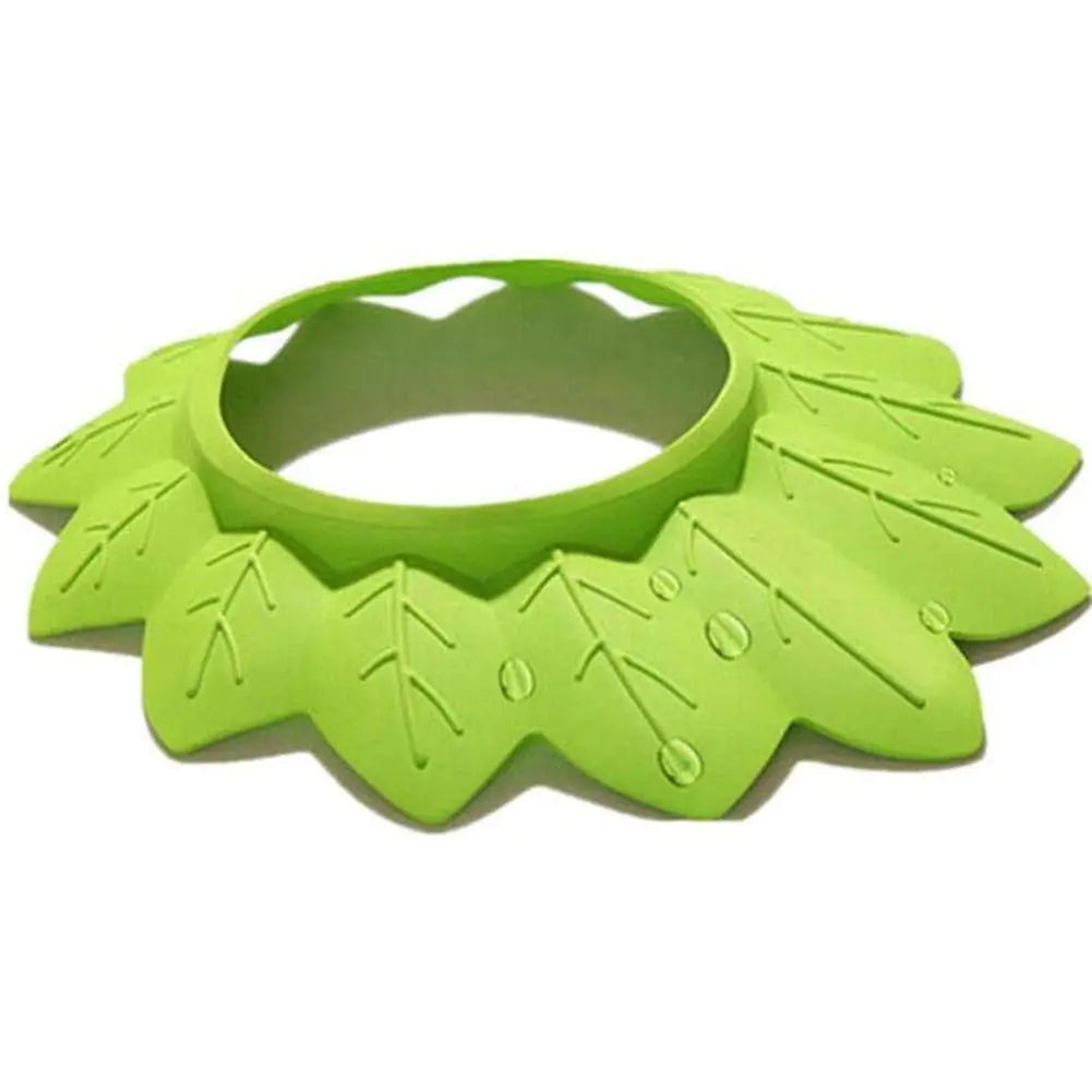 Green silicone bib with leaf patterns on a white background