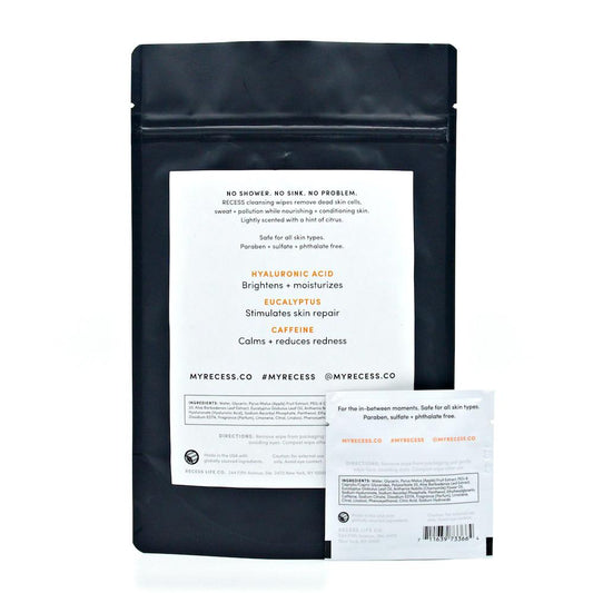 Black skincare packaging with white label on a white background