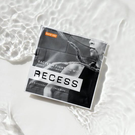 Biodegradable face wipe pouch with RECESS branding and FACE 201 orange label