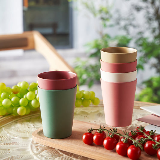 Bamboo tumblers stacked in pink, white, green, and dark red