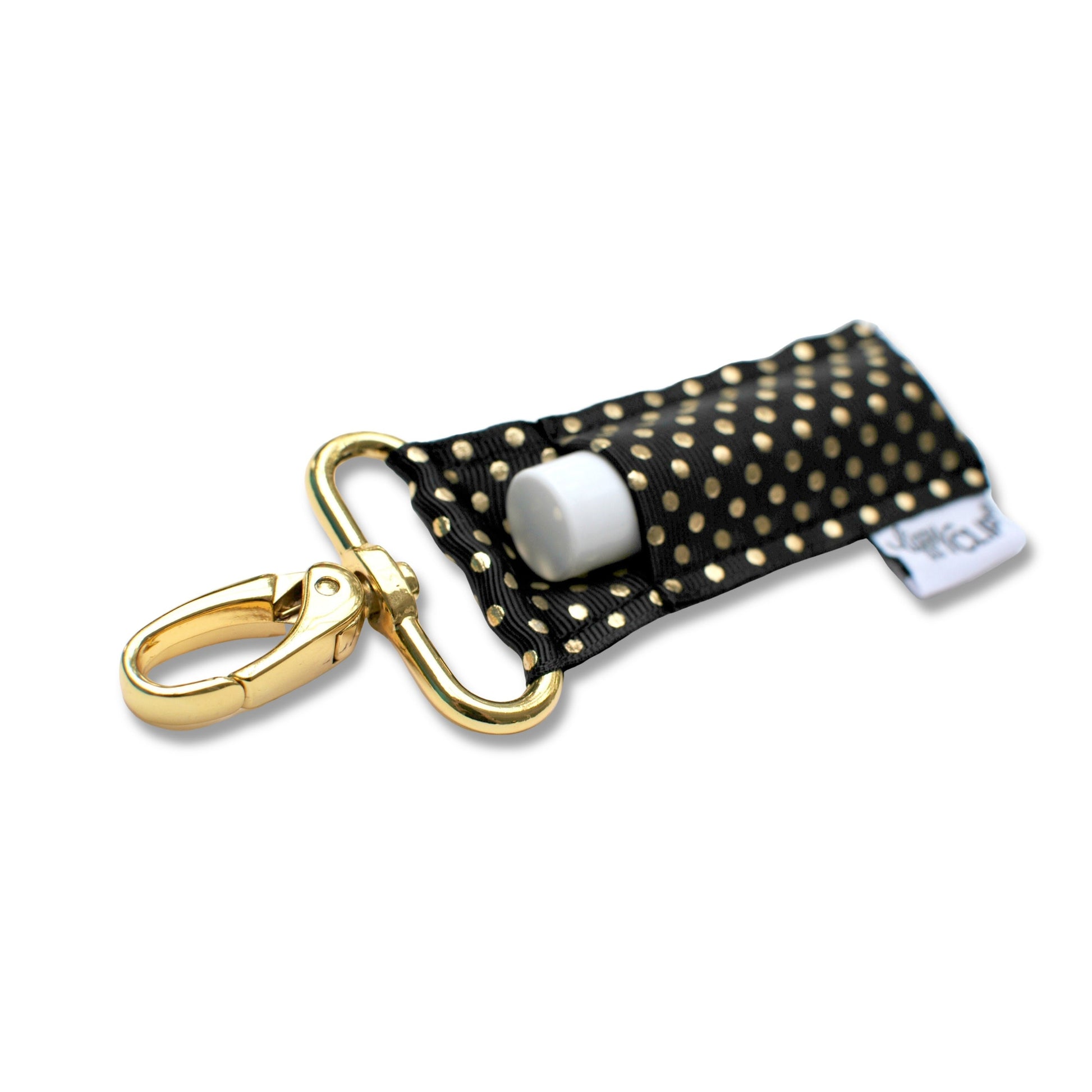 Black polka dot keychain with gold clasp on a white background