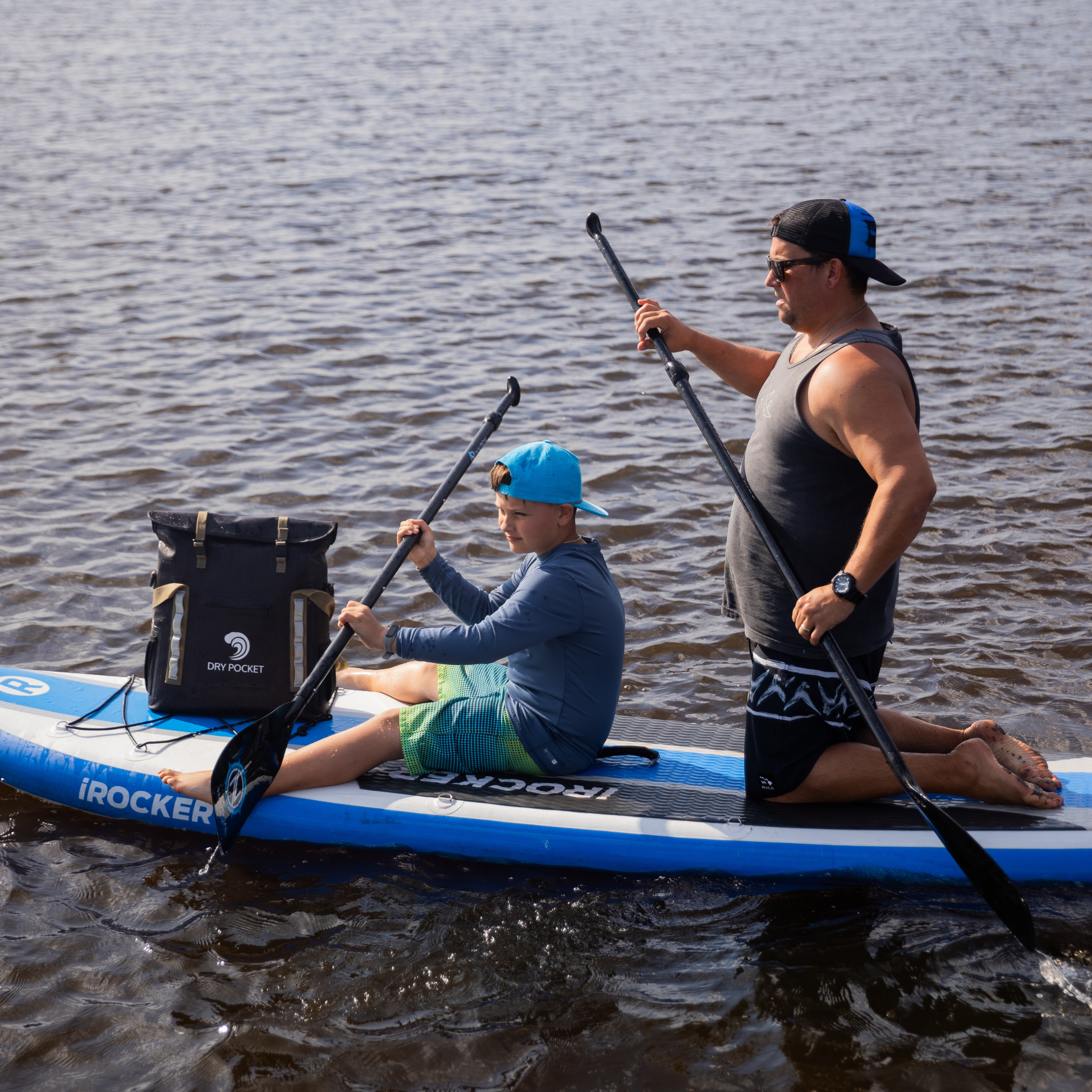 Waterproof floating tote cooler in dark gray on inflatable boat, with white straps