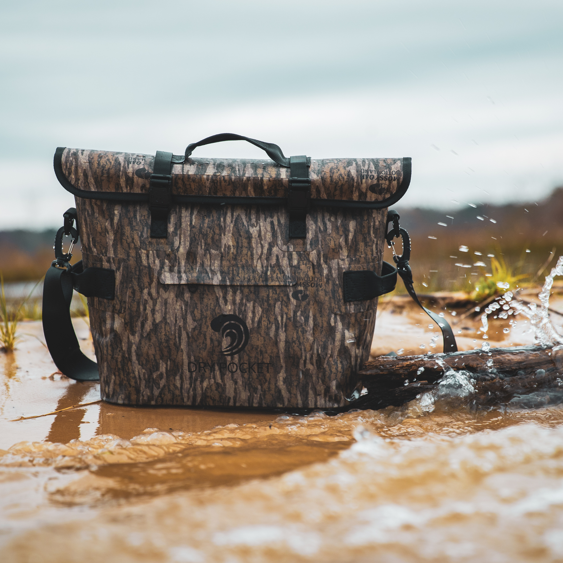 Waterproof floating cooler bag in Mossy Oak camo floating on water with splash