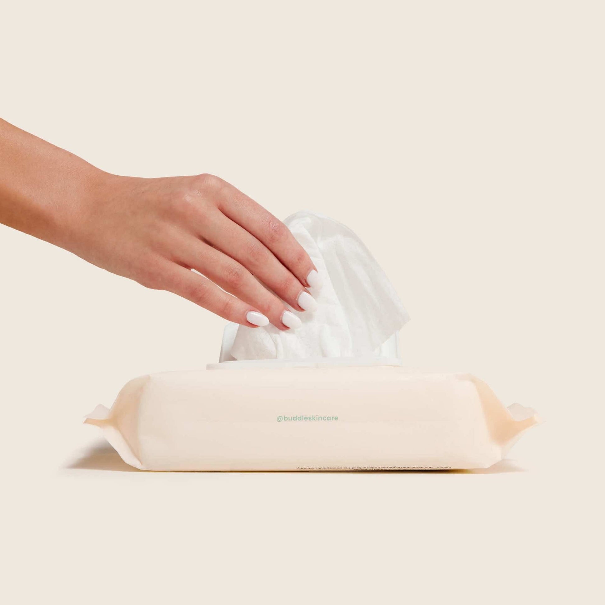 Baby wipes pack with wipes pulled up by a hand