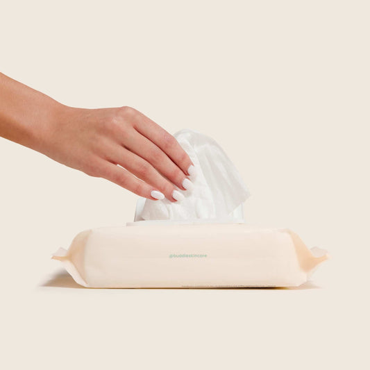 Baby wipes pack with wipes pulled up by a hand