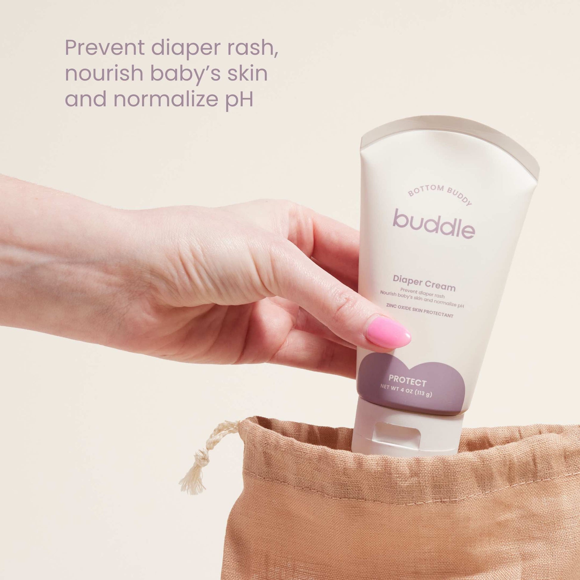 Diaper cream tube held in hand, buddle Protect