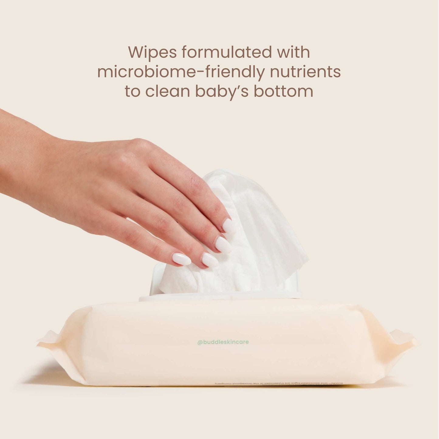 Baby wipes tub with lid open and wipe pulled up by hand