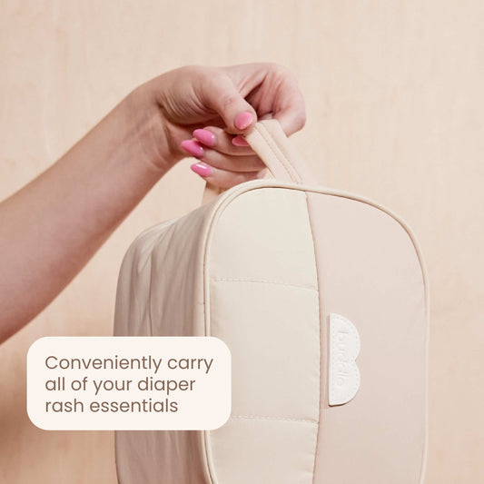 Beige diaper changing bag with side handle and stitched logo patch