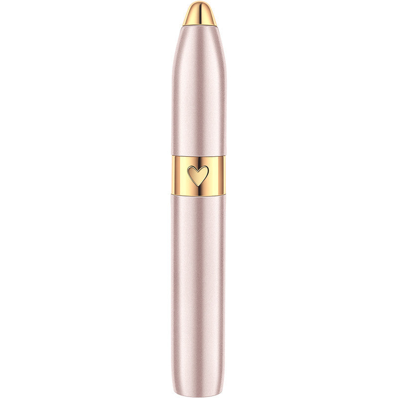 Rechargeable electric eyebrow trimmer in champagne gold with heart medallion