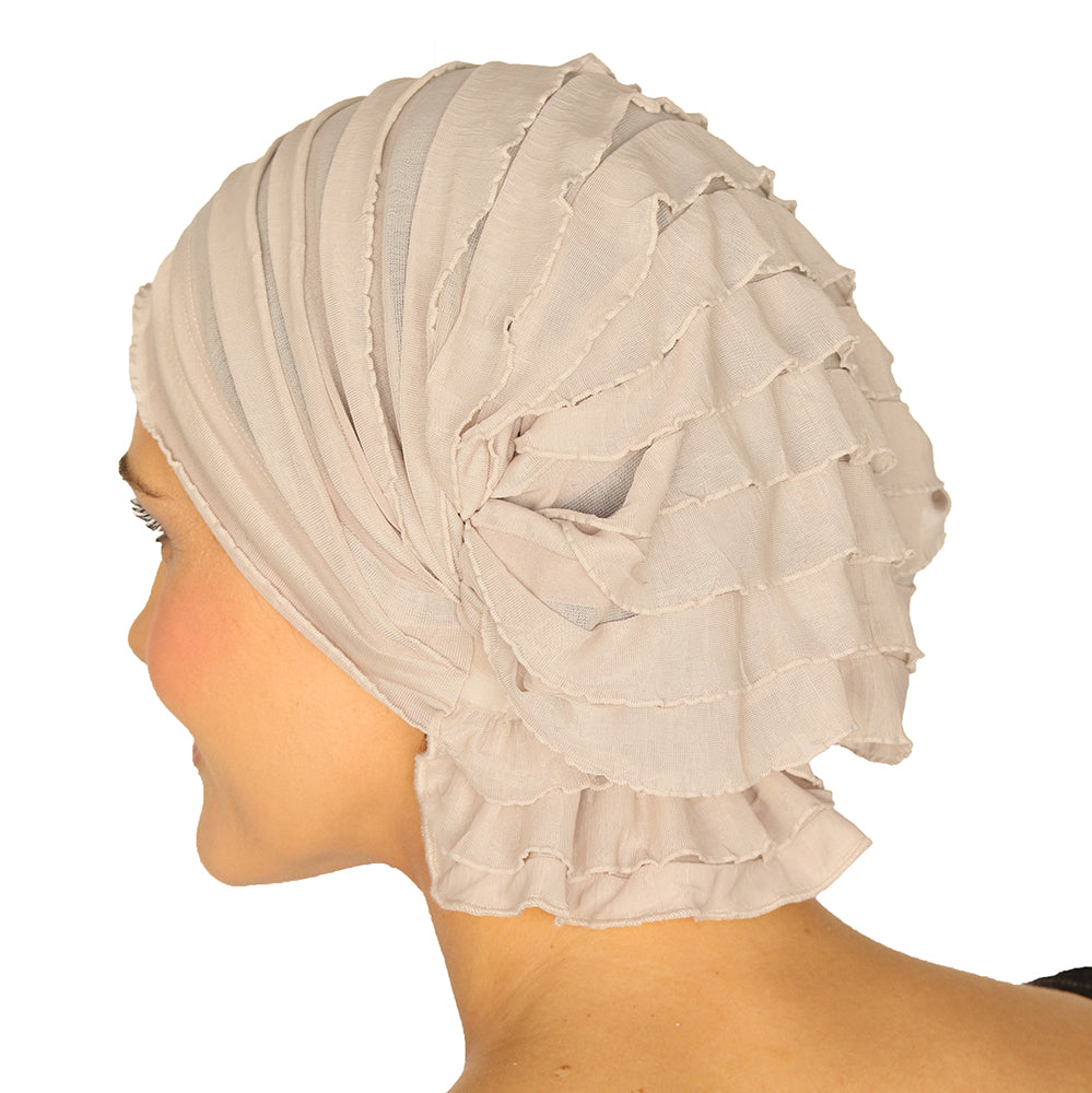Beige ruffled headscarf viewed from the side with layered ruffles