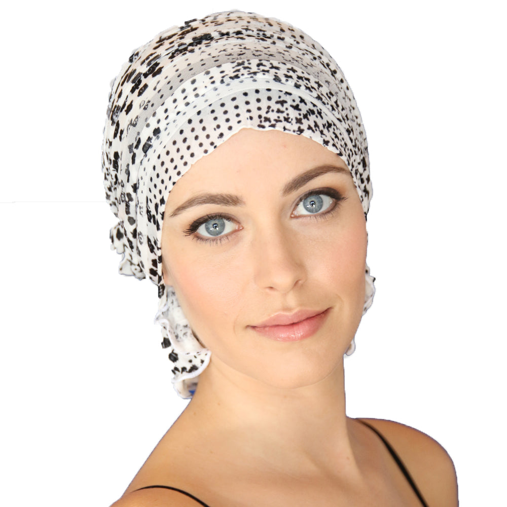 Speckled chemo beanie cap with side knot, white with dark dot pattern