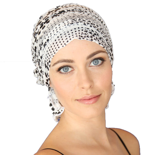Speckled chemo beanie cap with side knot, white with dark dot pattern