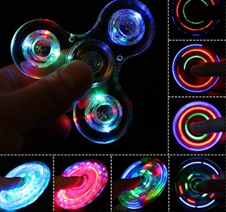 Blue LED fidget spinner close-up with glowing lenses and rainbow light details
