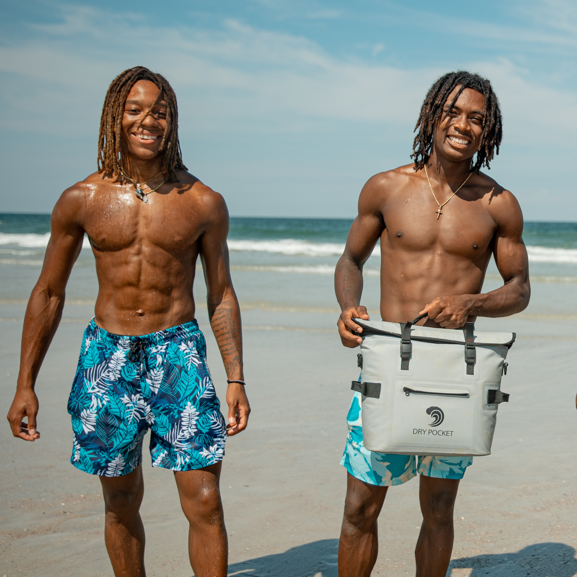 Men's waterproof swim shorts with teal and white tropical leaf print, drawstring elastic waist