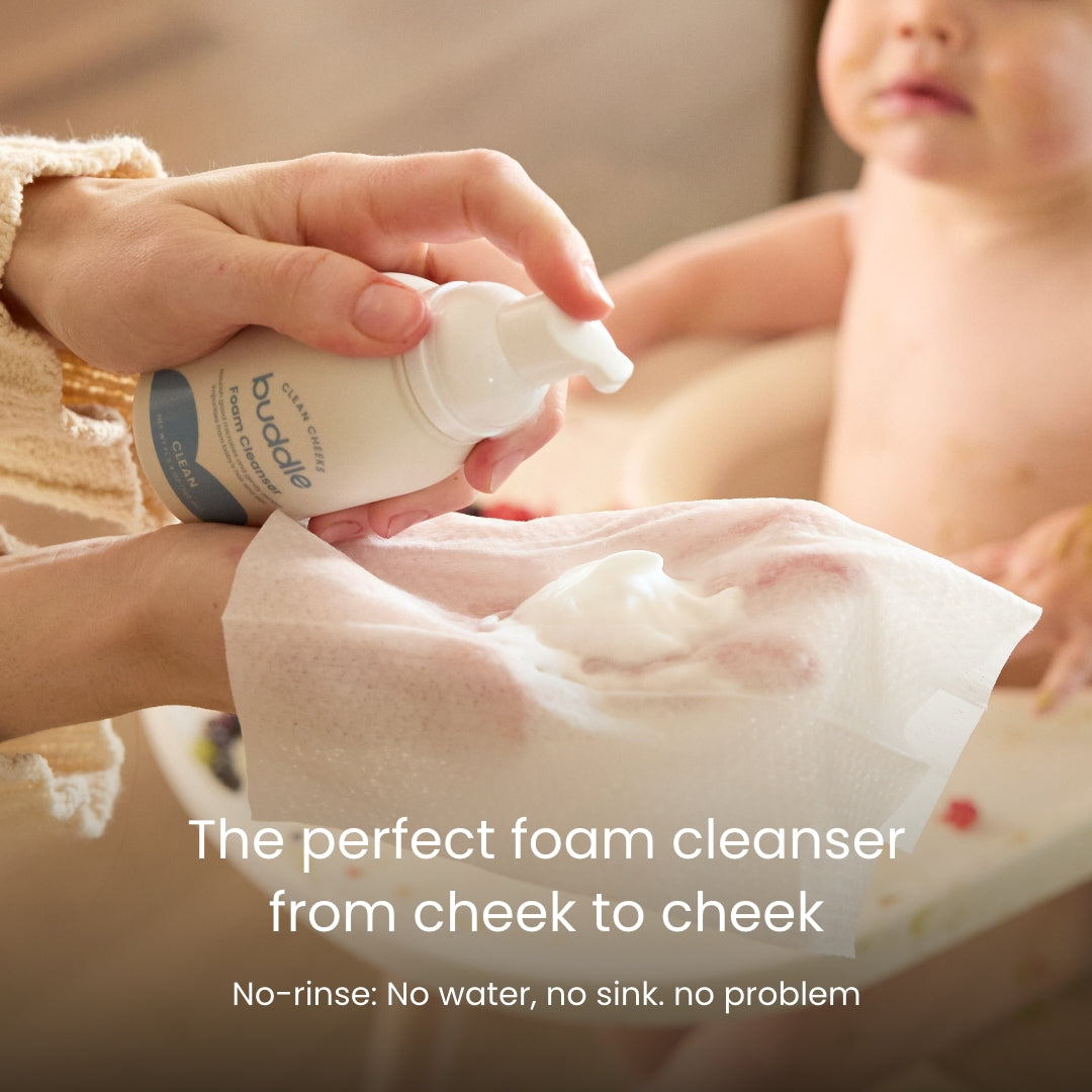 Foam cleanser pump dispensing white foam onto baby skin.