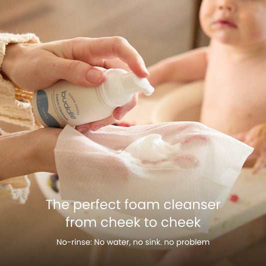Foam cleanser pump dispensing white foam onto baby skin.
