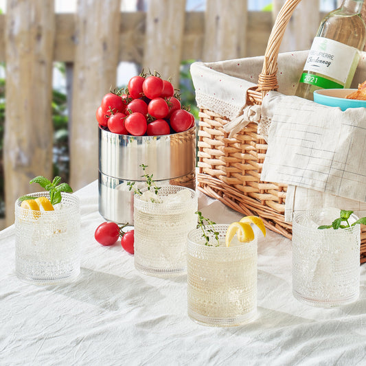 Four acrylic hobnail lowball glasses, clear textured sides with small raised dome bumps