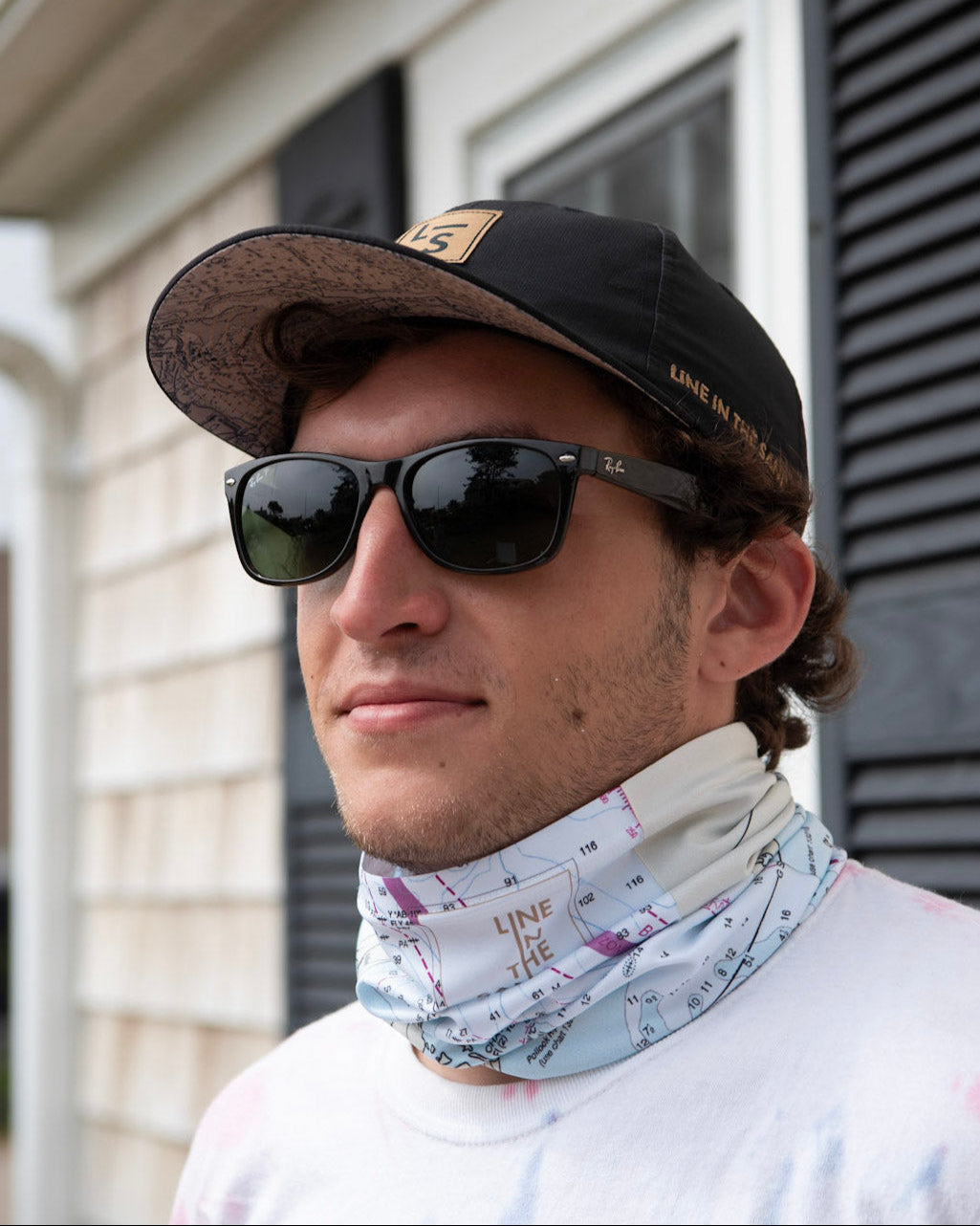 Solar gaiter with white nautical chart print, worn at neck by man