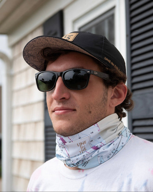 Solar gaiter with white nautical chart print, worn at neck by man