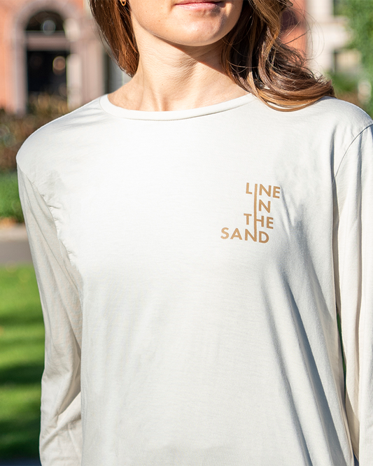 Unisex wave long-sleeve shirt, sand color, front text "LINE THE SAND"