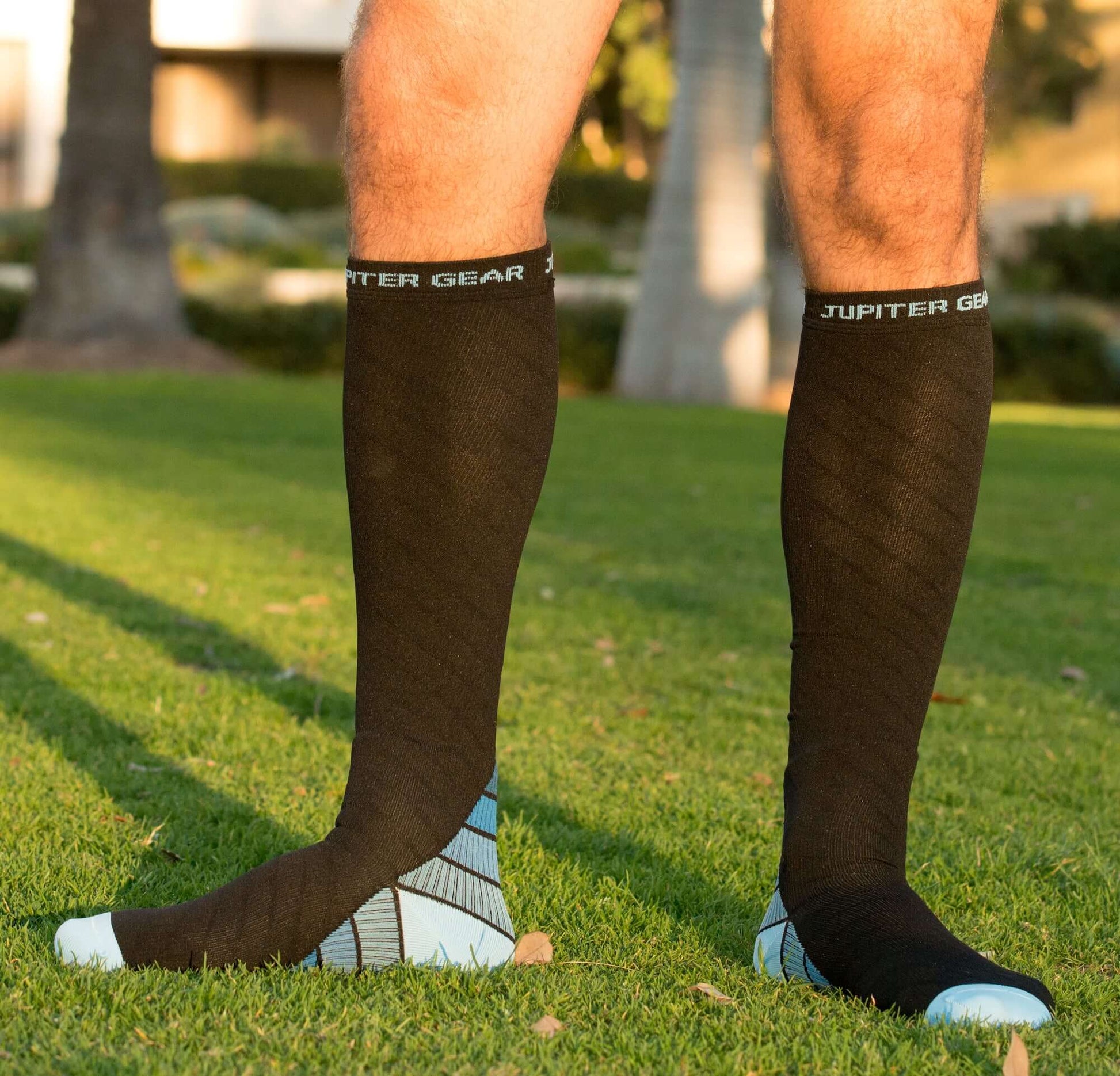 Dark compression socks with blue striping at foot and light blue heel/toe