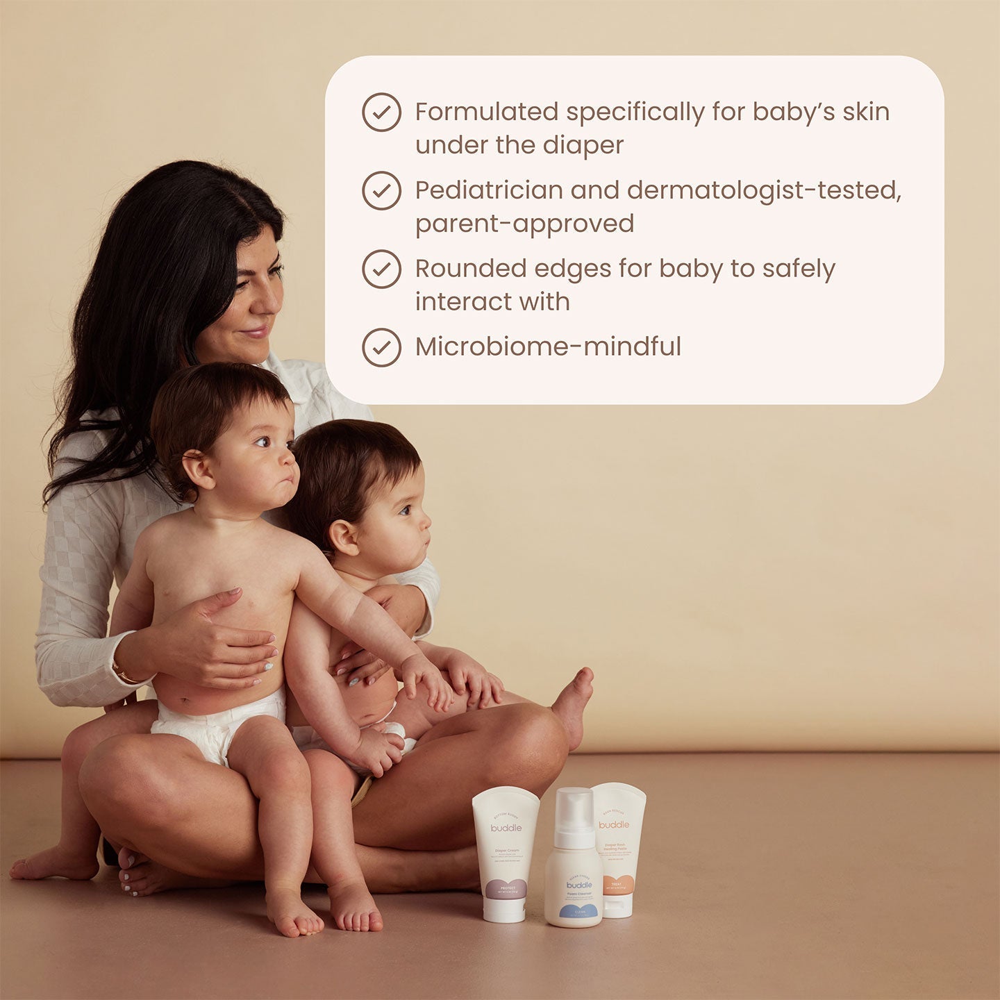 Diaper skincare system two bottles placed on surface with caregiver scene