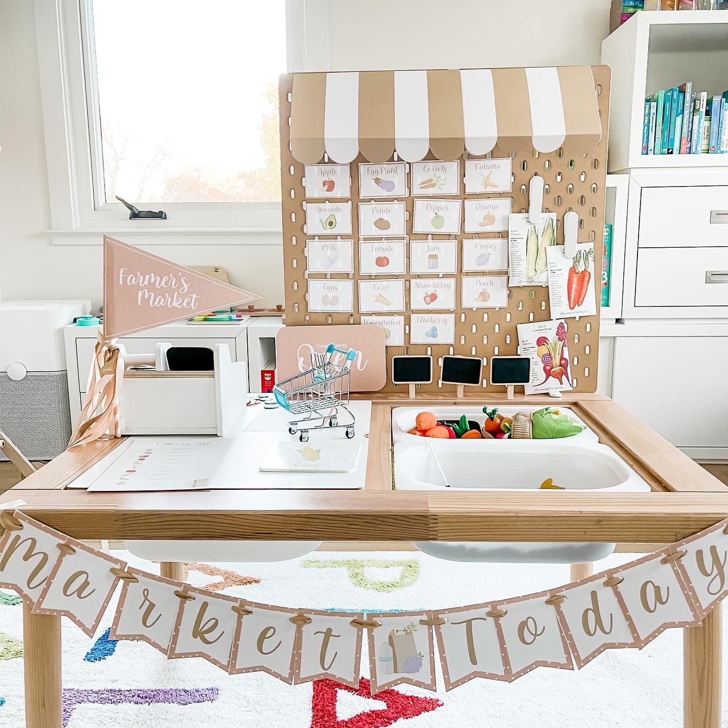 Farm market playset with pegboard card grid, open register sign, and small accessories
