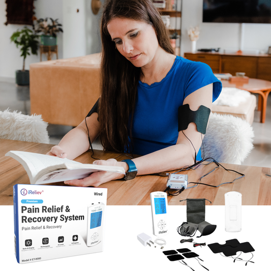Wired TENS+EMS pain relief device with black gel pads applied to forearm during use