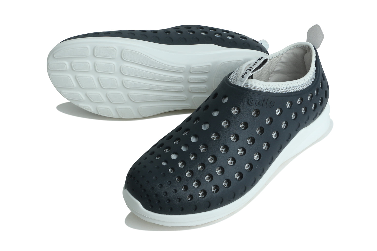 Black slip-on water shoe shown from outsole side with perforated upper and white sole