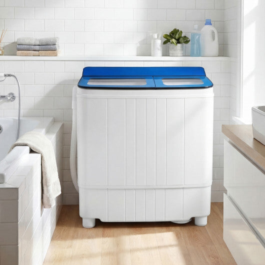 Portable washing machine with blue top lid, front view in a bathroom