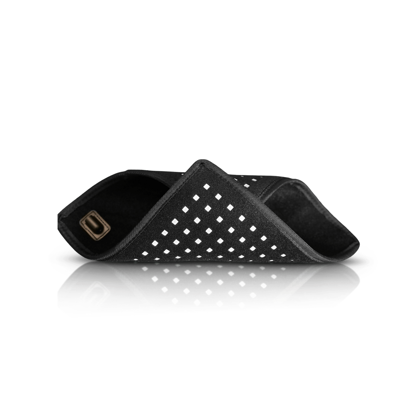 Folded black LED therapy pad with dotted white grid and two attached strap loops
