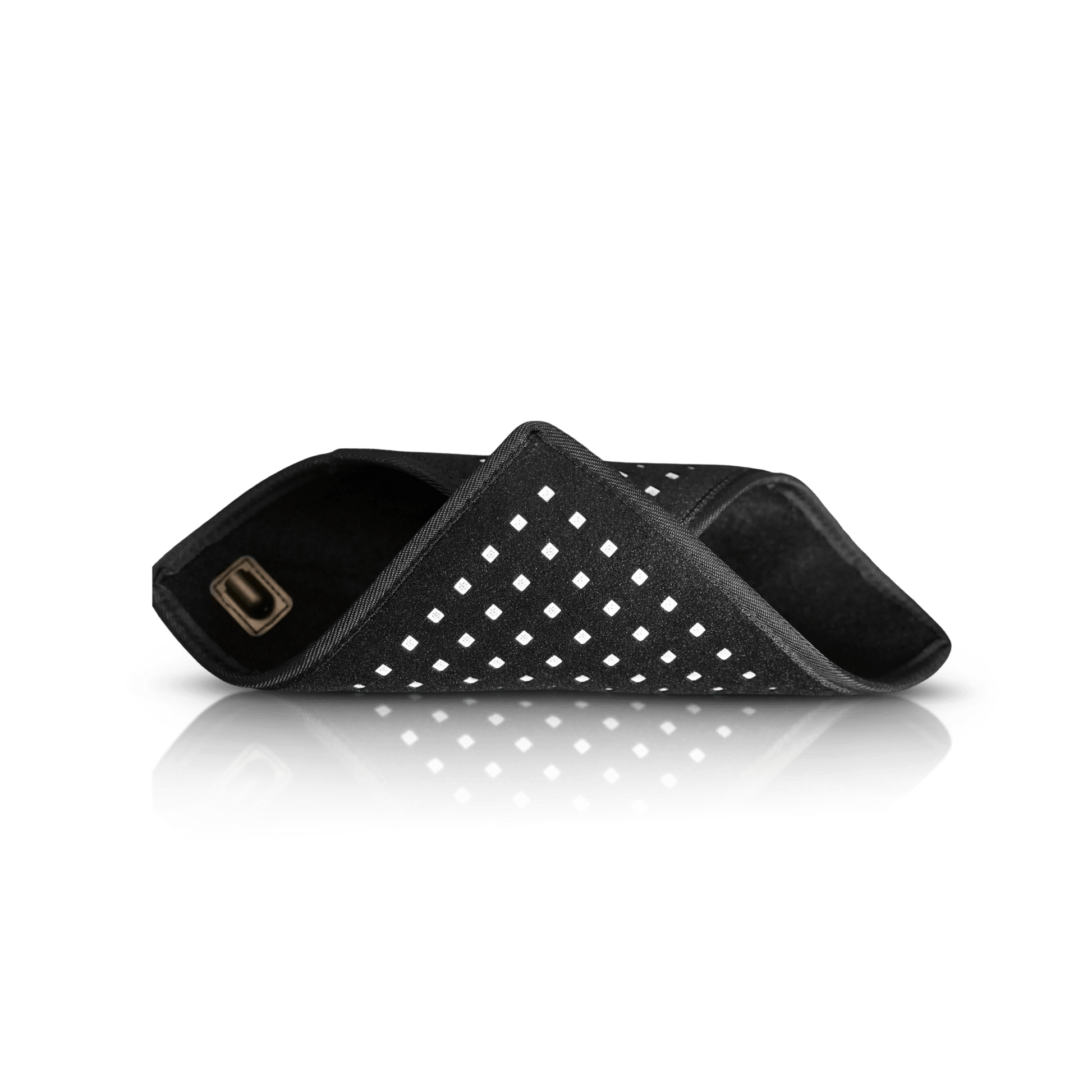 Folded black LED therapy pad with dotted white grid and two attached strap loops