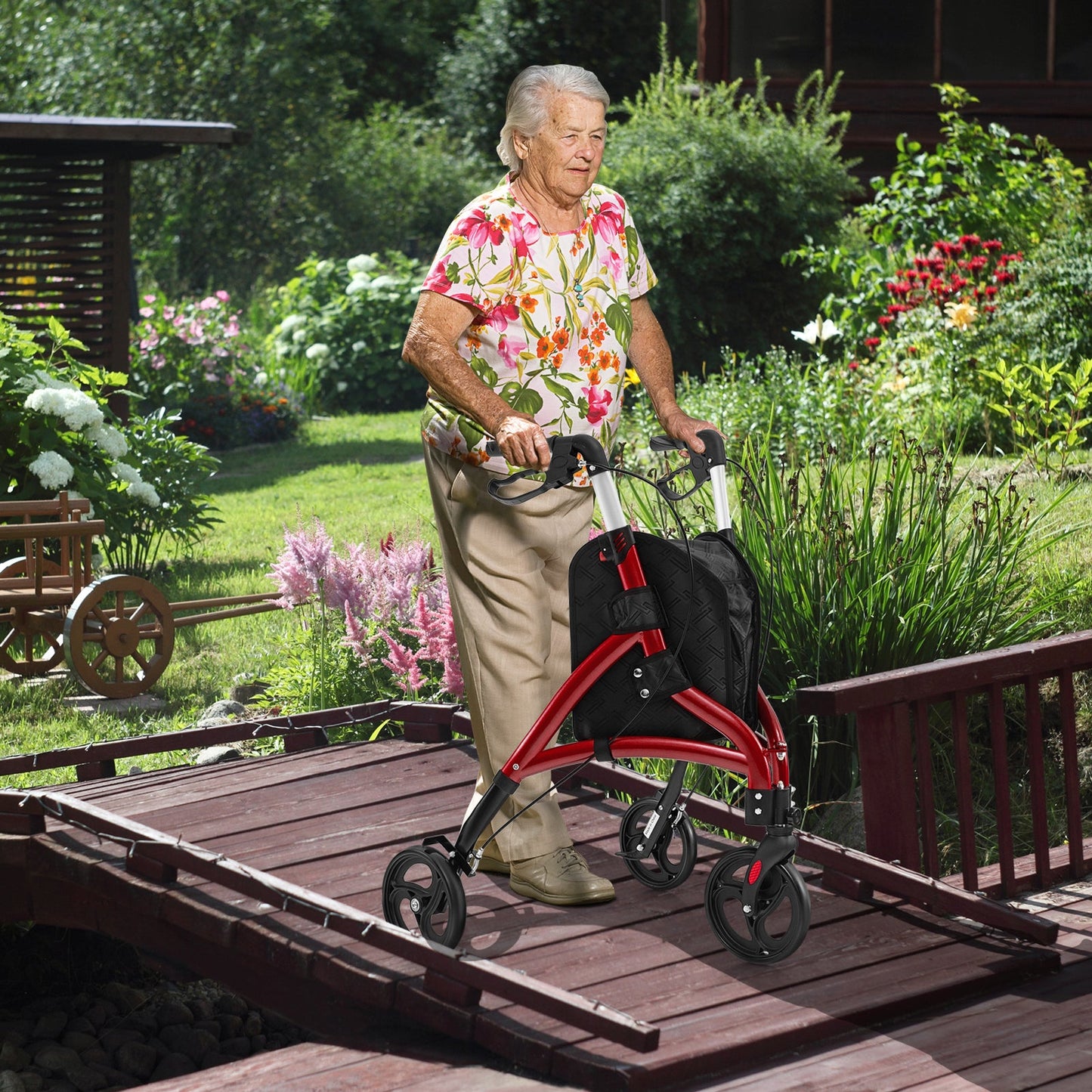 Senior woman using a red rollator in a garden setting