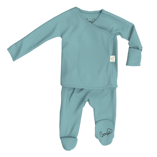 Teal baby outfit with long-sleeve top and footed pants on a white background