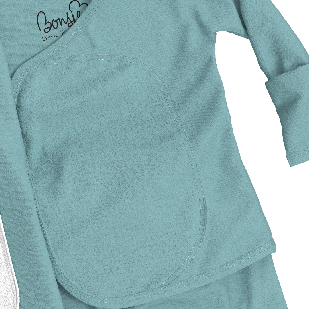 Teal long-sleeve top with a brand logo on a white background