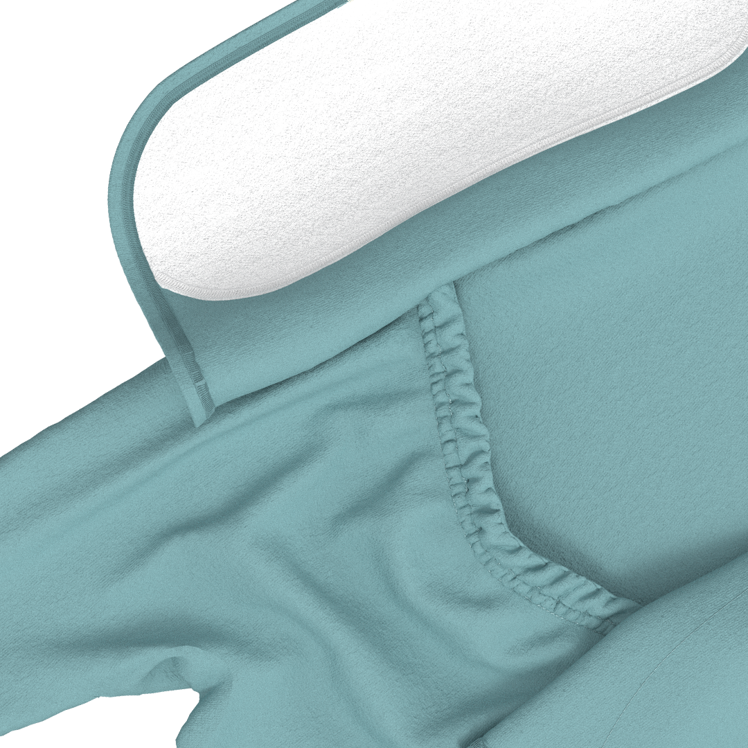 Teal fitted sheet with white pillowcase on a bed