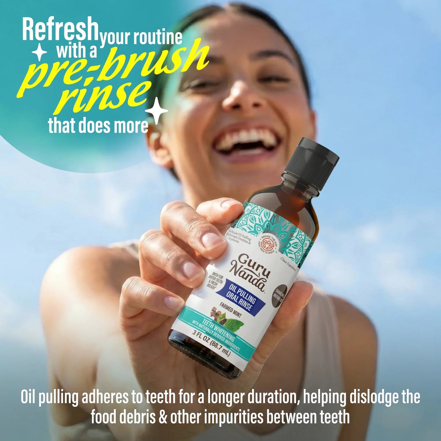 Oil pulling oral rinse bottle held up by a smiling person, turquoise label facing forward