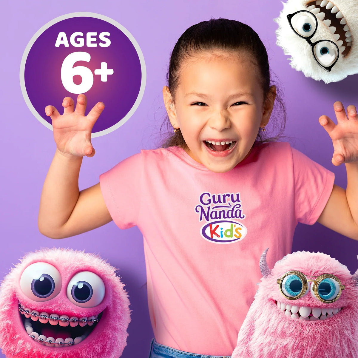 Smiling child wearing Guru Nanda Kids shirt with two monster character plush toys