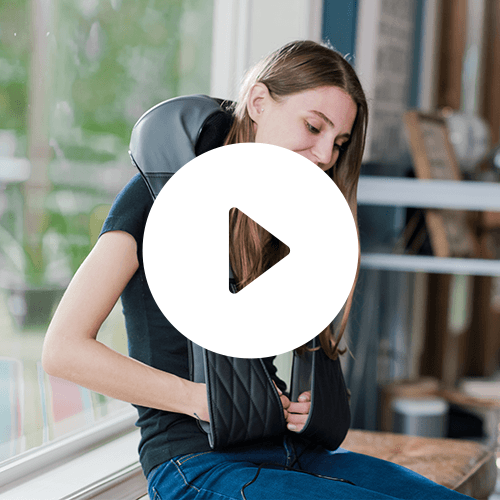 Shiatsu neck and back massager cushioning around a seated person’s upper back