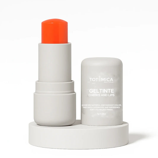 Gel tint for cheeks and lips with orange cap, white tube and cylindrical container