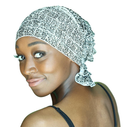 Leopard-print head wrap with ruffled edge, side view of speckled black-and-white fabric