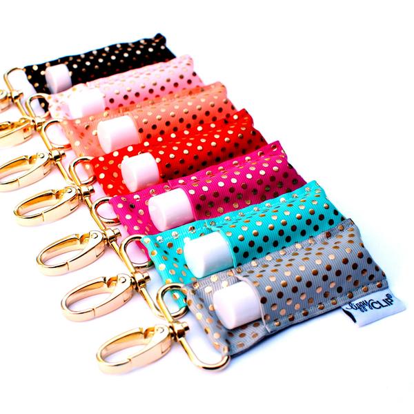 Set of colorful keychains with polka dot patterns on a white background