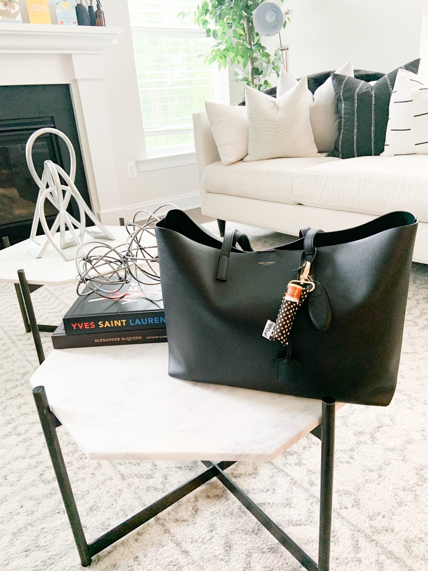 Black handbag on a chair in a living room setting