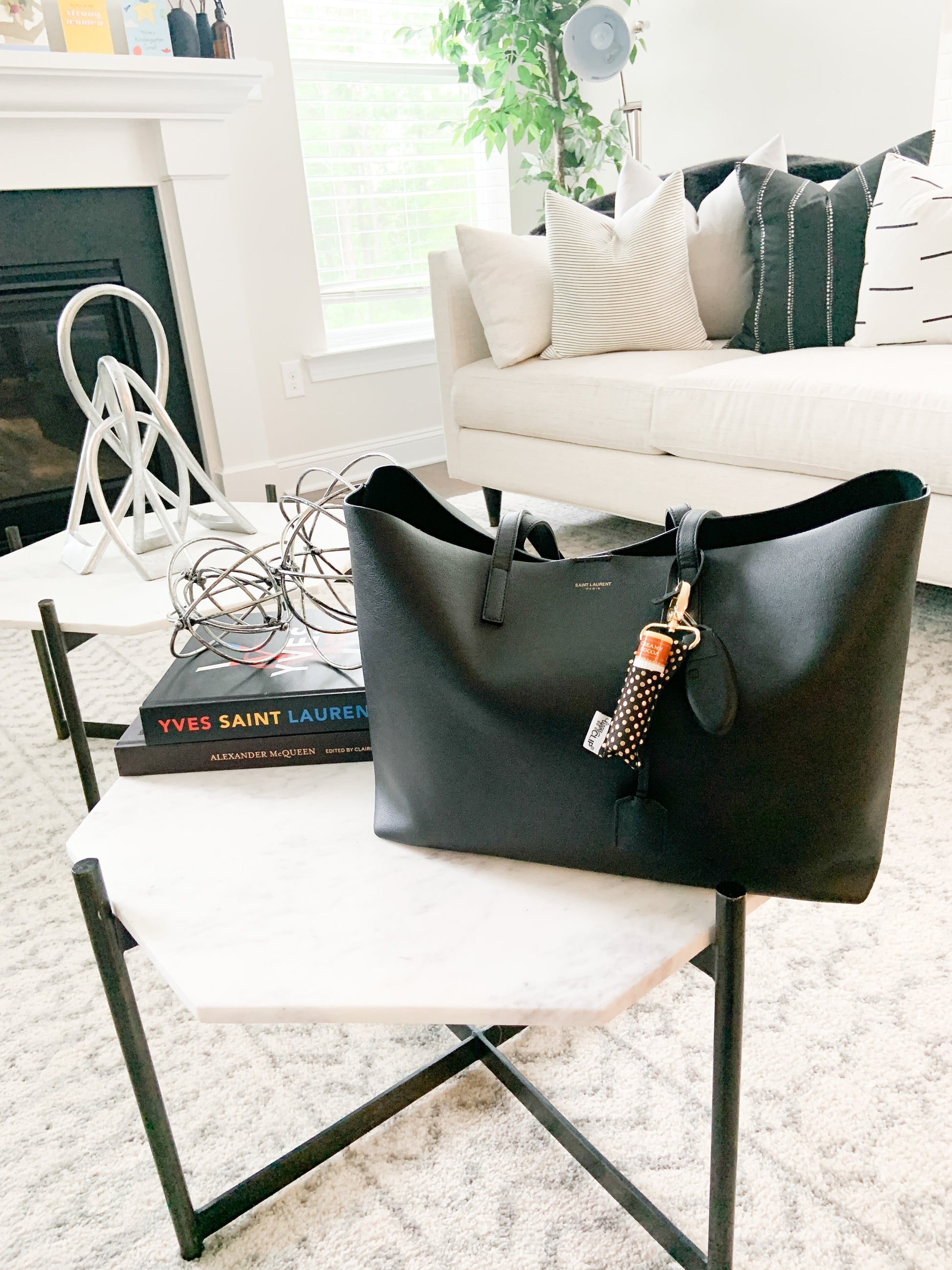 Black handbag on a chair in a living room setting