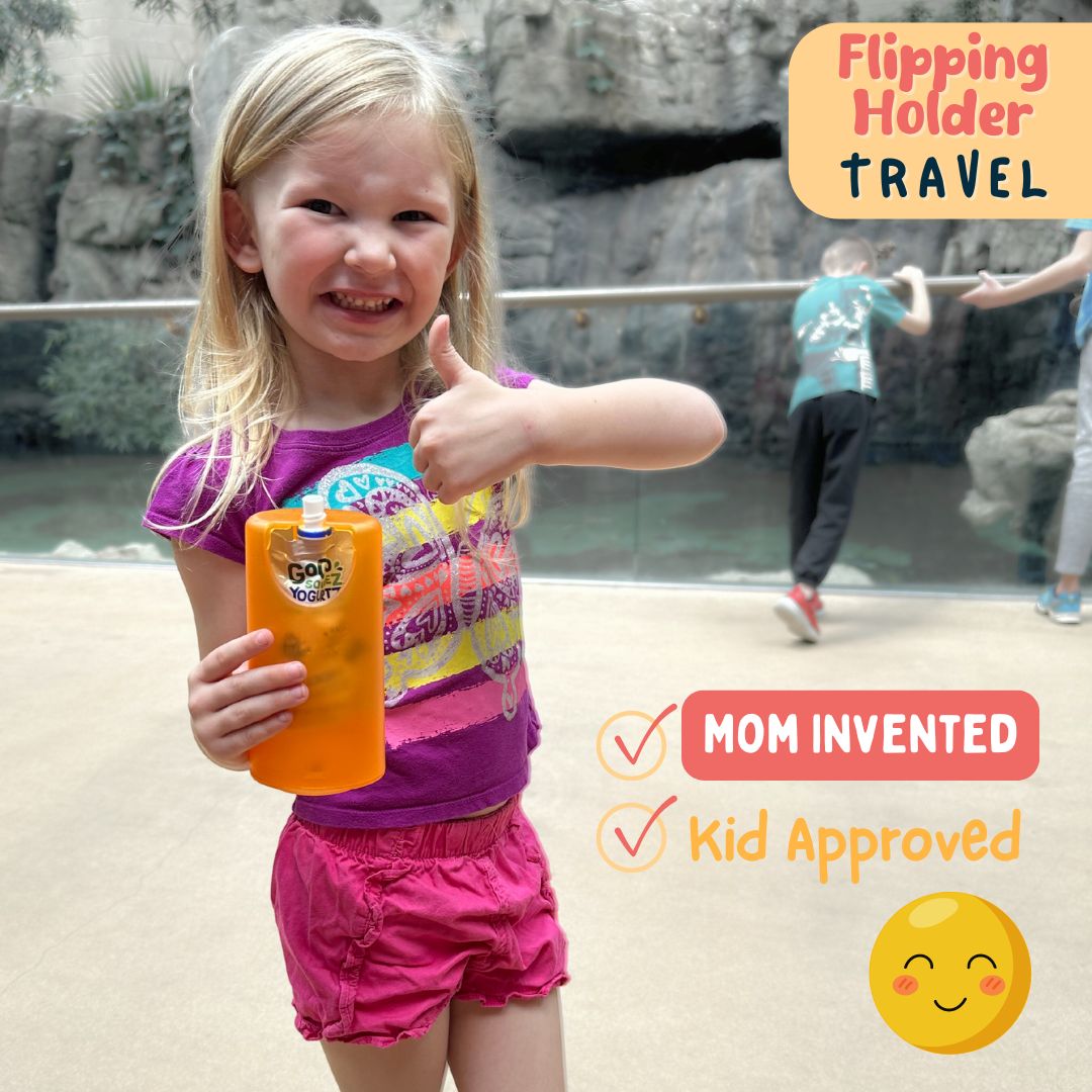 Flipping travel holder, orange juice box container with green cap held by a child